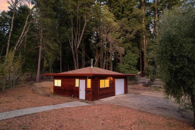 view of home's community featuring an outbuilding