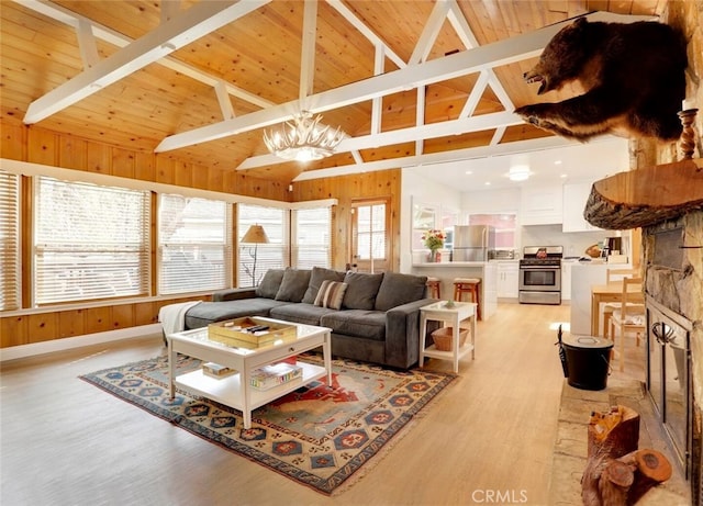 living room featuring an inviting chandelier, wood ceiling, light hardwood / wood-style floors, high vaulted ceiling, and beam ceiling