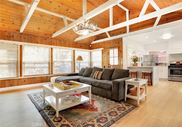 living room with high vaulted ceiling, beam ceiling, light wood-type flooring, and wooden ceiling