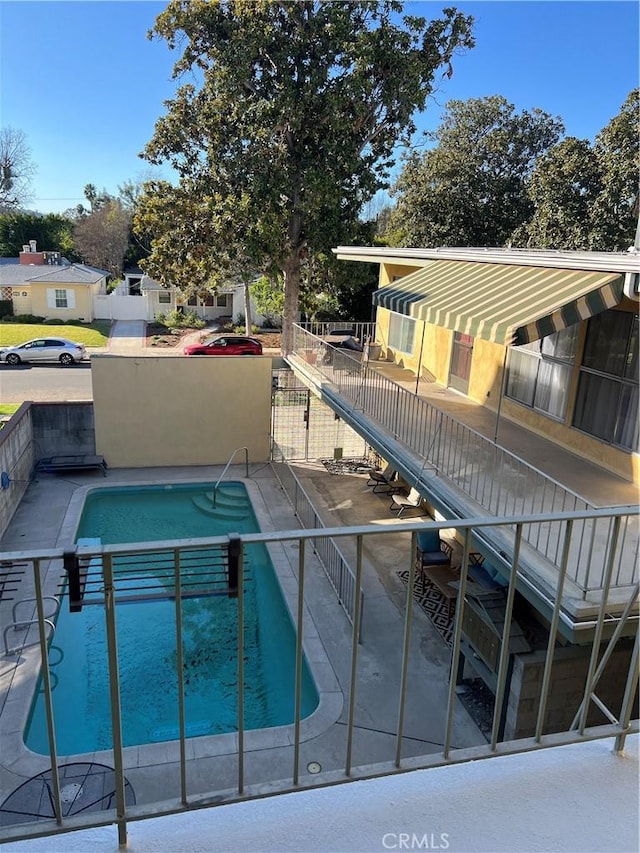 view of swimming pool with a patio area