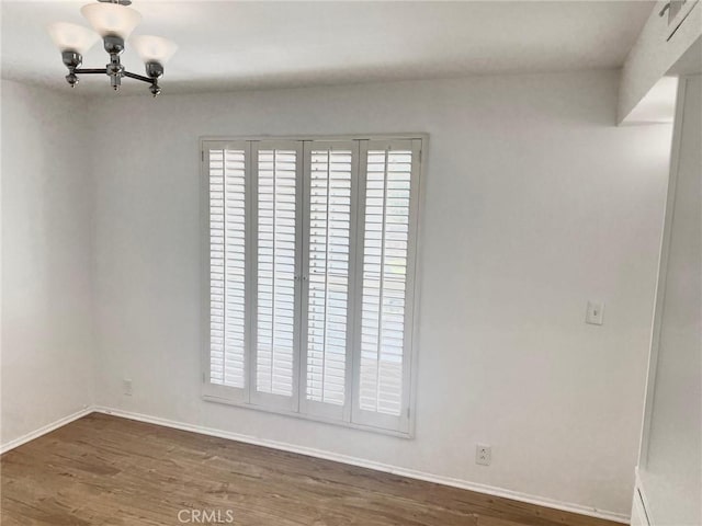 unfurnished room featuring a healthy amount of sunlight, baseboards, and dark wood-style flooring