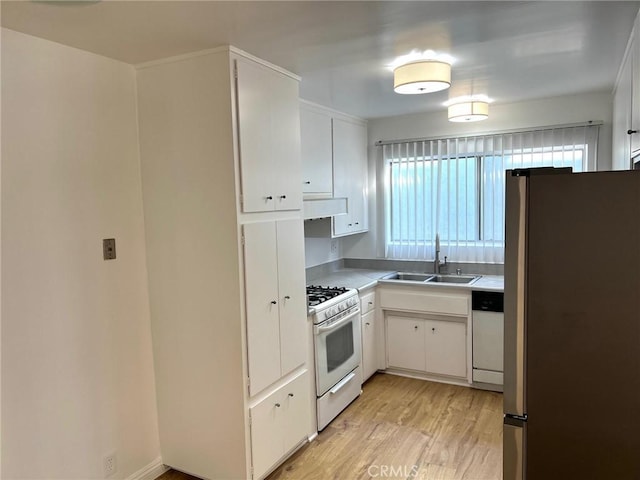 kitchen featuring a sink, under cabinet range hood, white appliances, white cabinets, and light wood finished floors