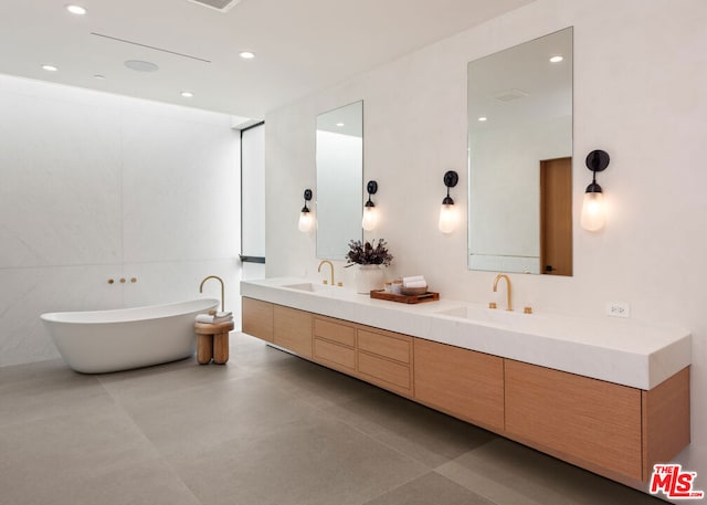 bathroom featuring vanity, a bathtub, and tile patterned floors