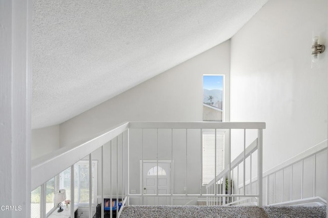 staircase featuring vaulted ceiling and a wealth of natural light