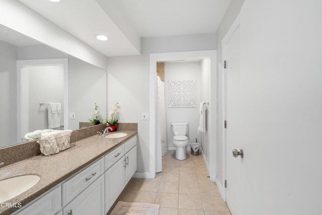 bathroom featuring toilet, vanity, and tile patterned floors