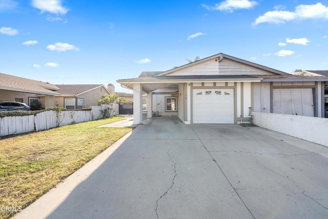 ranch-style home with a garage, concrete driveway, fence, and a front lawn