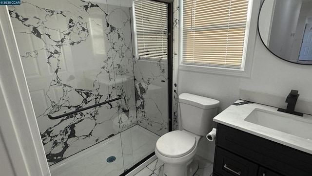 bathroom with a shower with shower door, toilet, and vanity