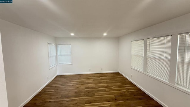 spare room with dark hardwood / wood-style flooring