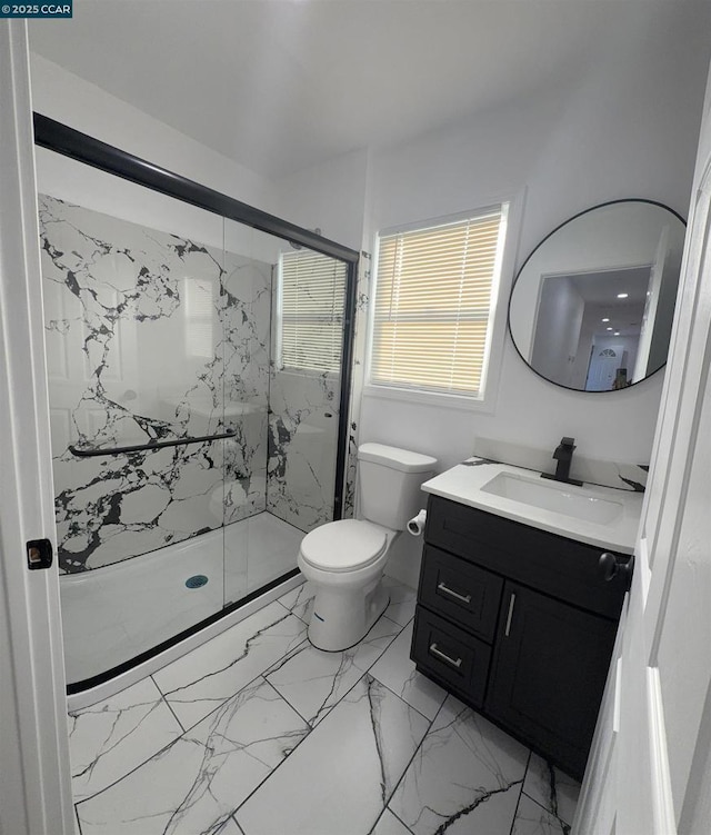 bathroom featuring an enclosed shower, vanity, and toilet