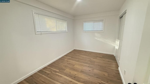 unfurnished room featuring wood-type flooring