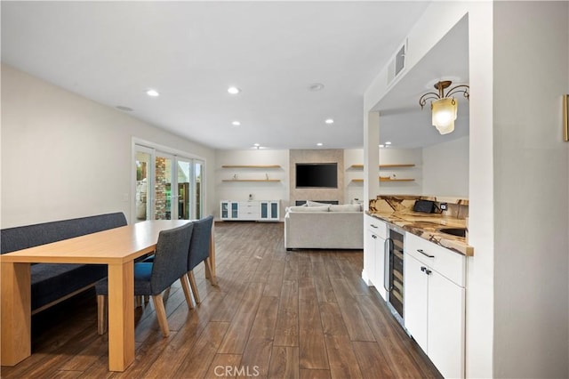 kitchen with white cabinetry, wine cooler, dark hardwood / wood-style flooring, and light stone counters