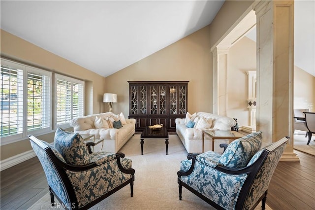 living room featuring vaulted ceiling and hardwood / wood-style floors