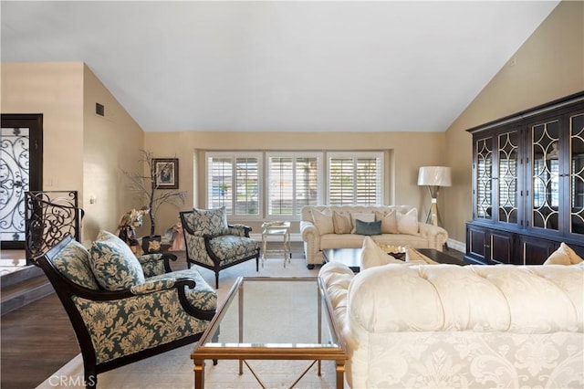 living room featuring vaulted ceiling and hardwood / wood-style flooring