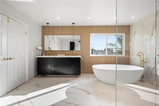 bathroom with a tub to relax in and vanity