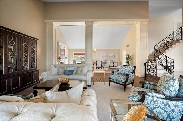 living room featuring wood-type flooring and decorative columns