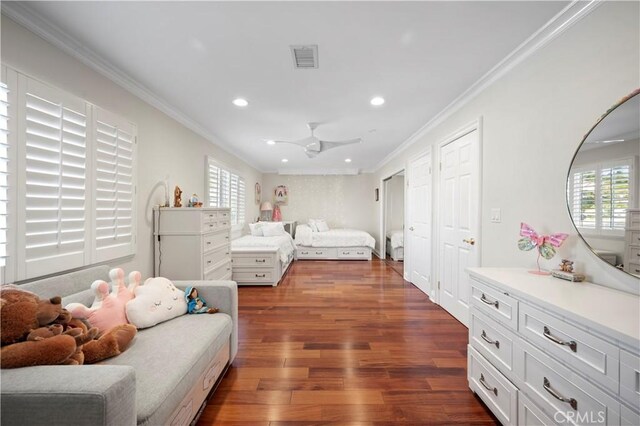 bedroom featuring ceiling fan, dark hardwood / wood-style flooring, and ornamental molding