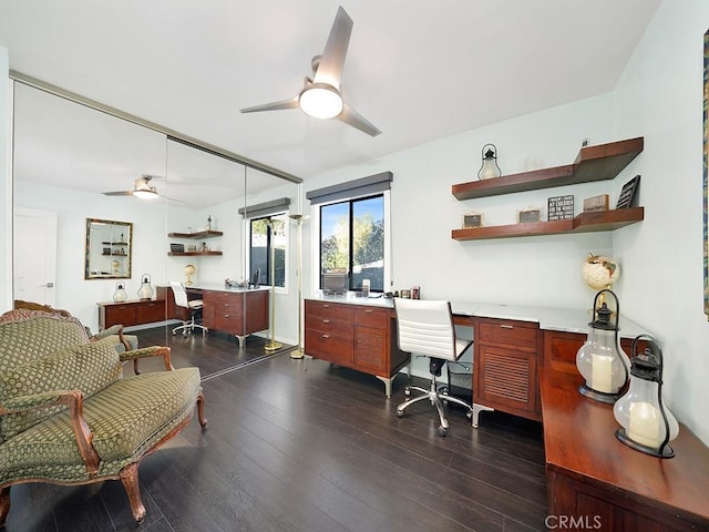 office area featuring ceiling fan, built in desk, and dark hardwood / wood-style floors