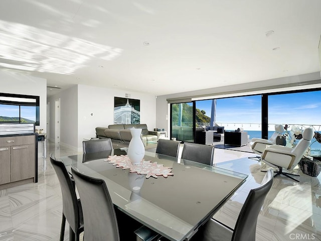 dining space featuring a water view