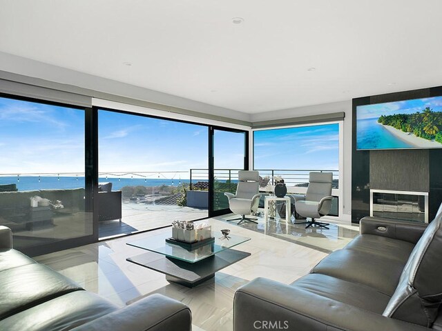 living room featuring a water view and plenty of natural light