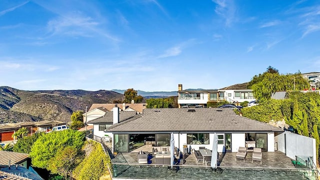 back of house featuring a mountain view, a patio area, and outdoor lounge area