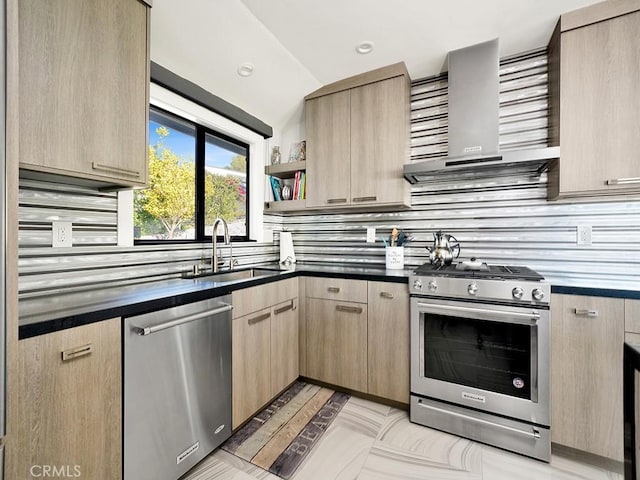 kitchen with stainless steel appliances, wall chimney exhaust hood, light brown cabinets, and sink