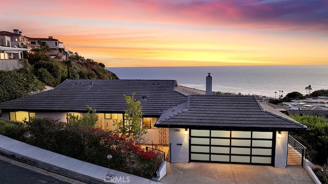 view of front of home featuring a garage and a water view