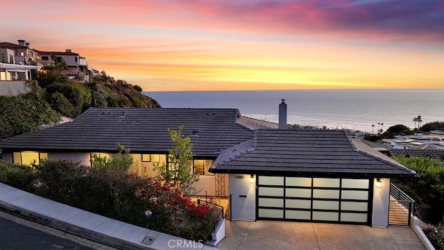 1380 Skyline Dr, Laguna Beach, CA 92651 - view of front of home with a water view, a garage, a tile roof, and stucco siding