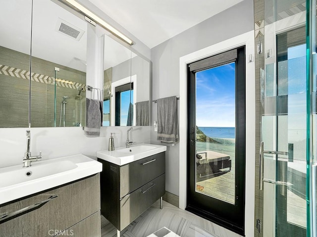 bathroom featuring a water view, vanity, and walk in shower