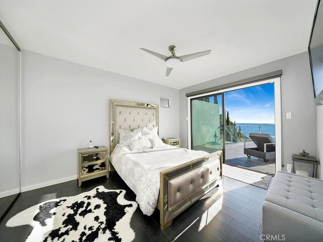 bedroom featuring ceiling fan, dark hardwood / wood-style floors, and access to outside