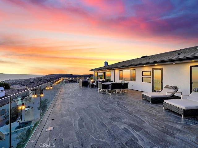 patio terrace at dusk with an outdoor living space