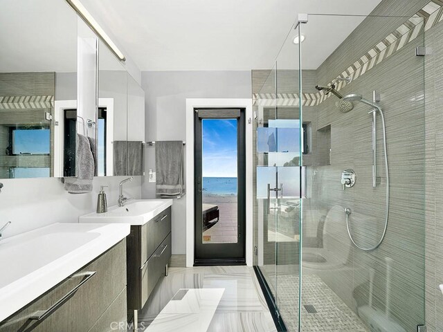 bathroom featuring a water view, a shower with shower door, and vanity