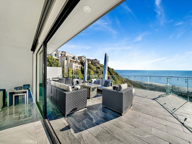 view of patio featuring an outdoor living space and a water view