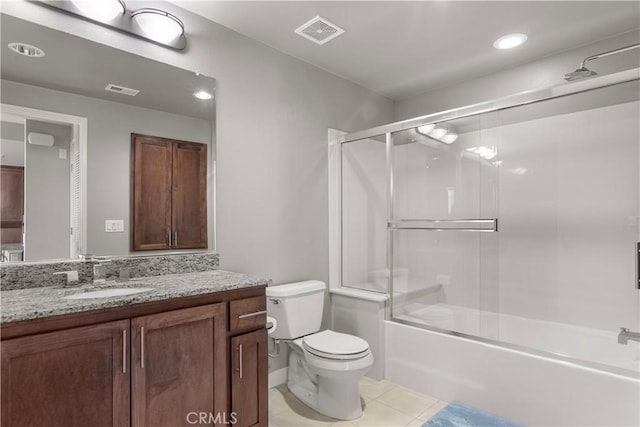 full bathroom featuring tile patterned floors, toilet, vanity, and shower / bath combination with glass door