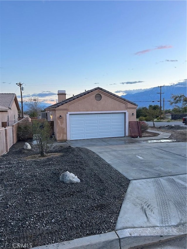66263 6th St, Desert Hot Springs, CA 92240 - garage featuring a mountain view, fence, and driveway