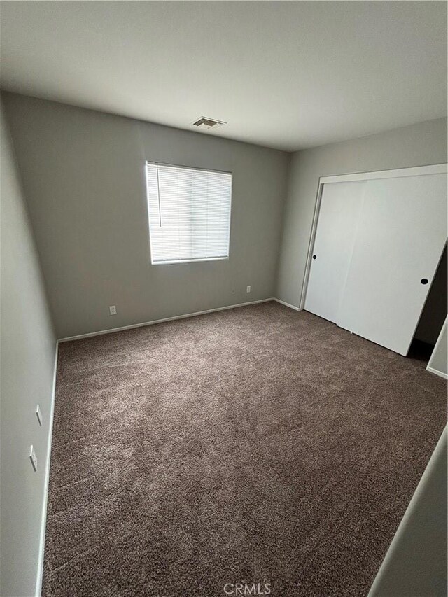 66263 6th St, Desert Hot Springs, CA 92240 - unfurnished bedroom with carpet floors, a closet, visible vents, and baseboards