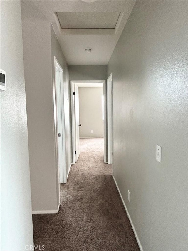 66263 6th St, Desert Hot Springs, CA 92240 - hallway with attic access, baseboards, and carpet floors