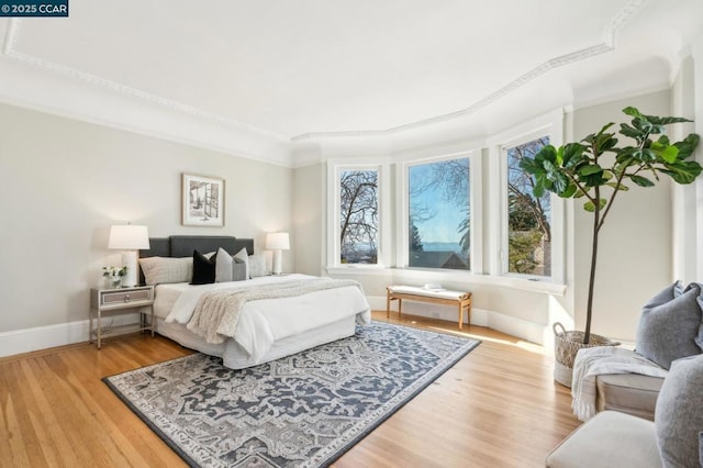 bedroom featuring crown molding and hardwood / wood-style floors