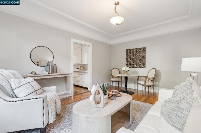 living room featuring crown molding and wood-type flooring