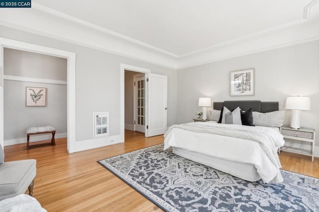 bedroom featuring hardwood / wood-style flooring and ornamental molding