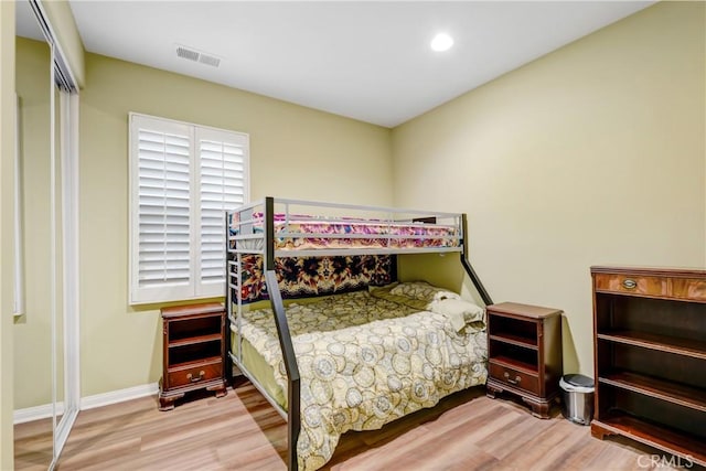 bedroom featuring a closet and light hardwood / wood-style flooring