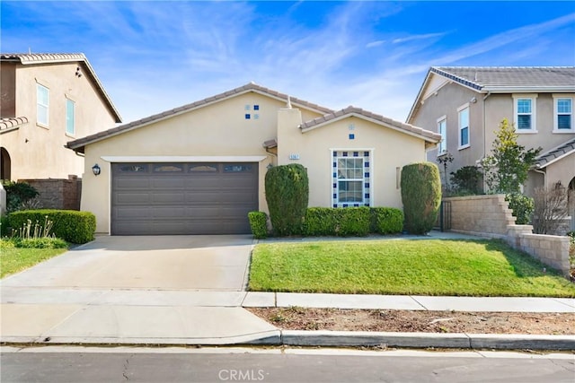 view of front of property featuring a garage and a front yard