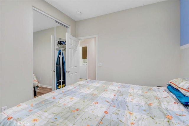 unfurnished bedroom with a closet and washer / clothes dryer