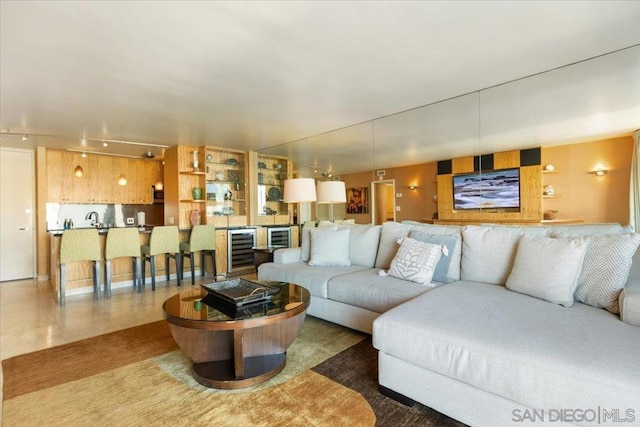 living room with sink, tile patterned floors, and beverage cooler