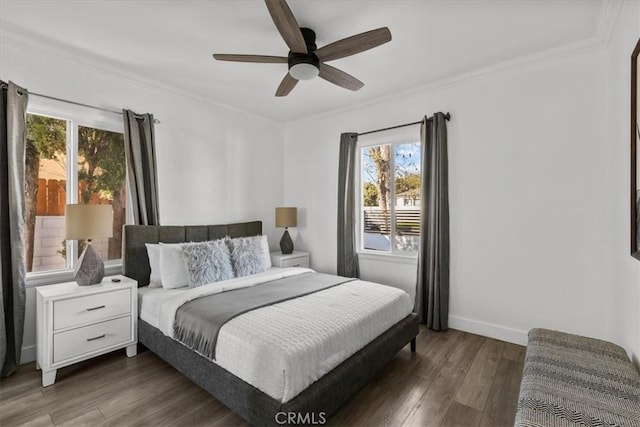 bedroom with dark wood-type flooring, ceiling fan, ornamental molding, and multiple windows