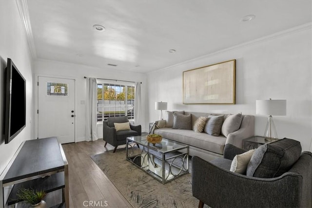 living room with hardwood / wood-style floors and crown molding