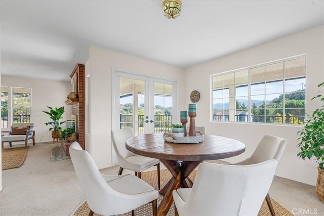 carpeted dining room with french doors