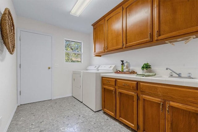 washroom featuring cabinets, separate washer and dryer, and sink