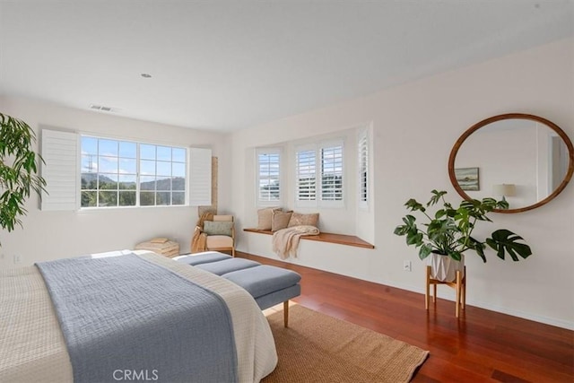 bedroom with dark wood-type flooring