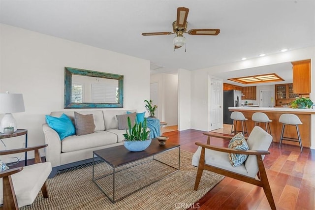 living room with ceiling fan and light hardwood / wood-style floors