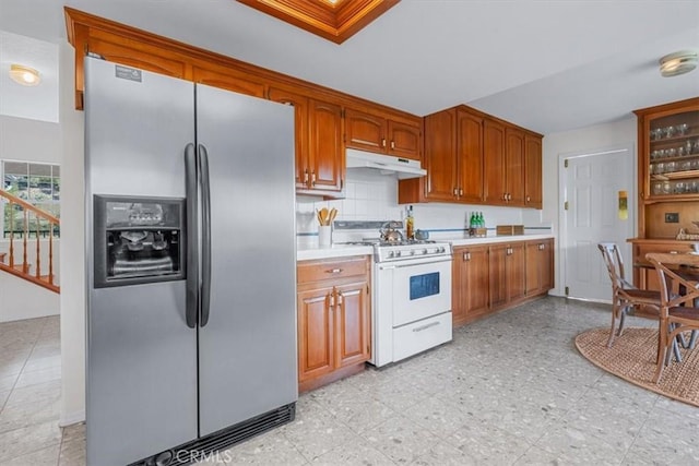 kitchen with white range with gas cooktop, backsplash, and stainless steel refrigerator with ice dispenser